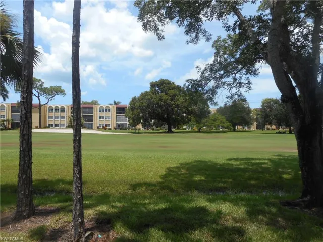 View of community featuring a yard and golf course view