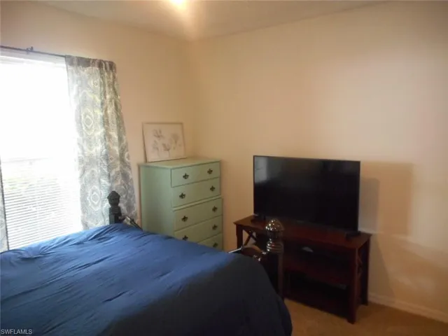 Bedroom with light colored carpet