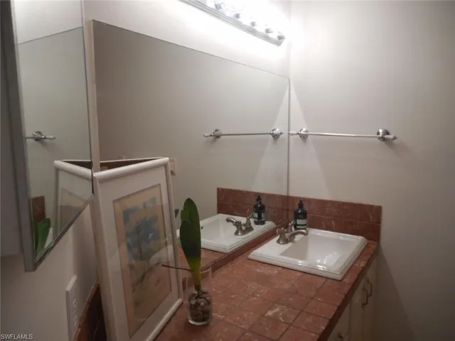 Bathroom featuring a garden tub and vanity