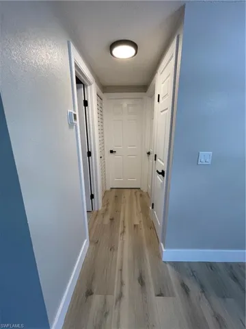 Corridor featuring light wood-type flooring