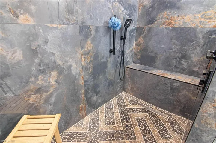 Bathroom with a marble finish shower