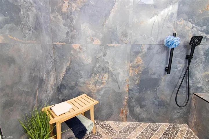 Bathroom featuring a sauna / steam room and a marble finish shower