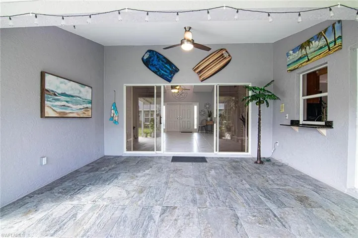 Property entrance featuring a ceiling fan and stucco siding