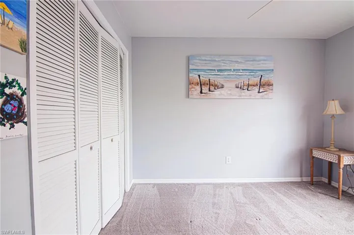 Unfurnished bedroom featuring a closet, light carpet, and ceiling fan
