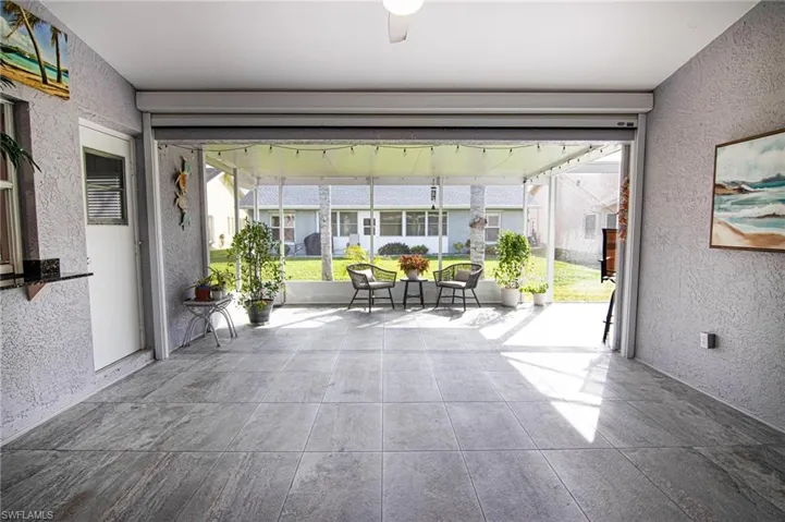 Sunroom featuring a textured wall and healthy amount of natural light