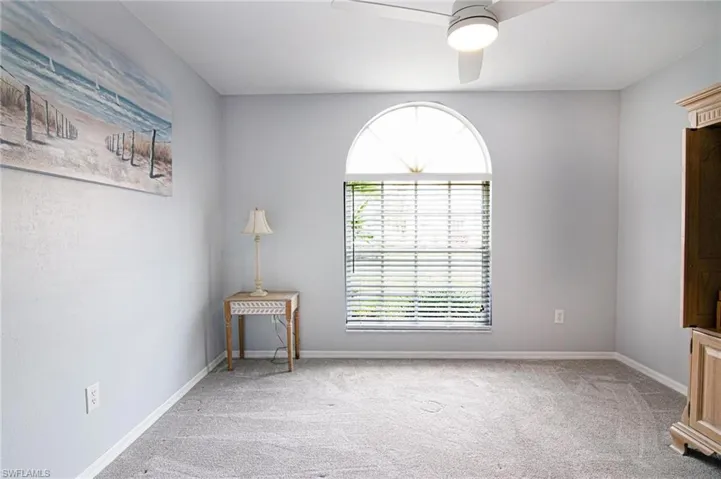 Spare room with light carpet and ceiling fan