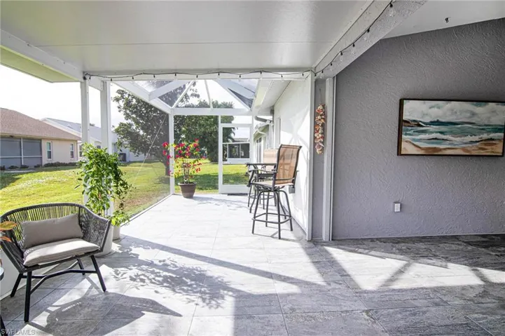 View of patio with a sunroom and glass enclosure