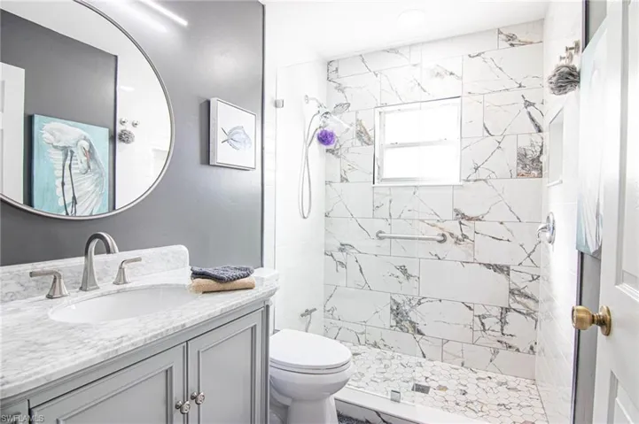 Full bathroom with vanity and a shower stall