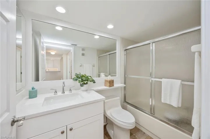 Guest Bathroom with vanity, enclosed tub / shower combo, and recessed lighting