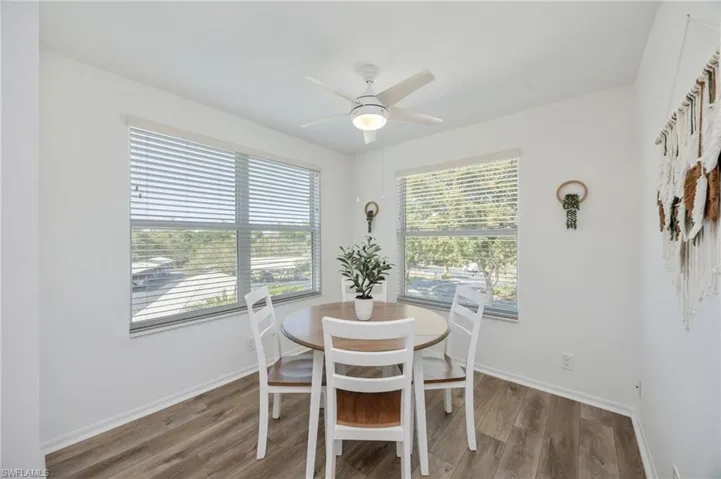Dining area with light wood-style floors, a ceiling fan, and healthy amount of natural light