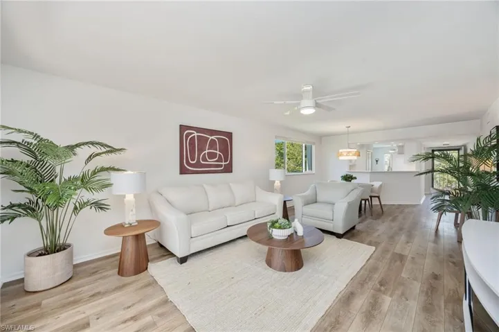 Living room with a ceiling fan and light wood finished floors