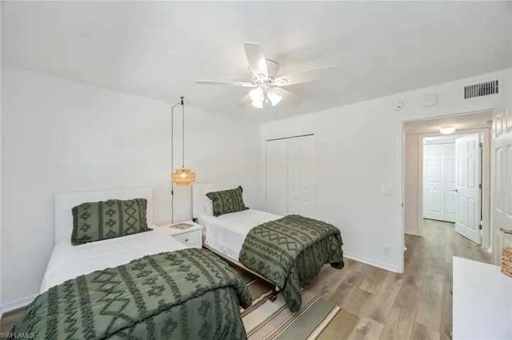 Bedroom featuring wood finished floors, ceiling fan, and a closet