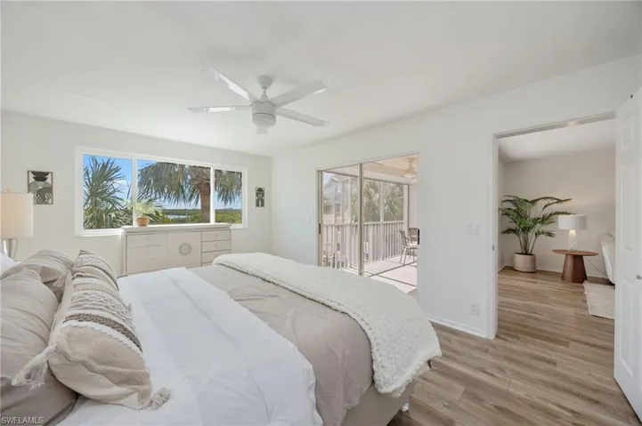 Bedroom featuring light wood-style flooring, access to exterior, and a ceiling fan