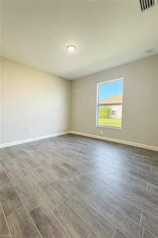 Empty room featuring wood finish floors and recessed lighting