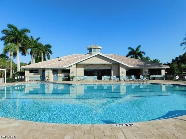 Community pool with a patio