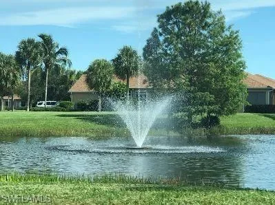 View of community with a water view and a lawn