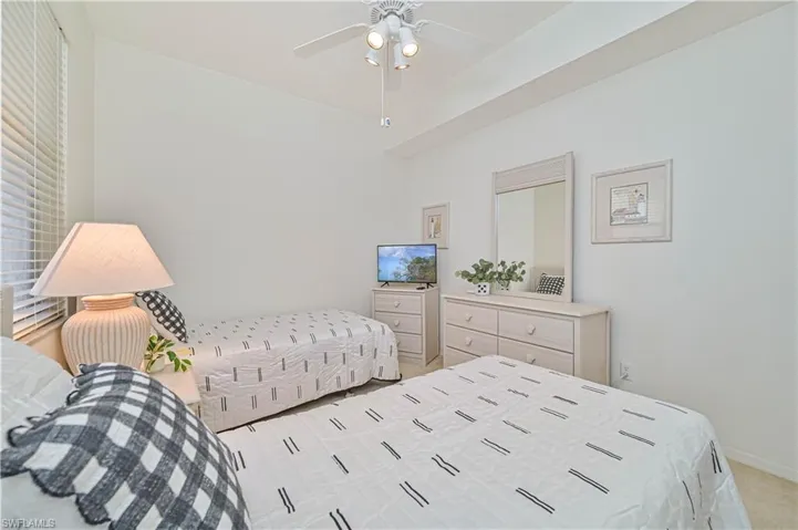 Bedroom featuring ceiling fan and light colored carpet