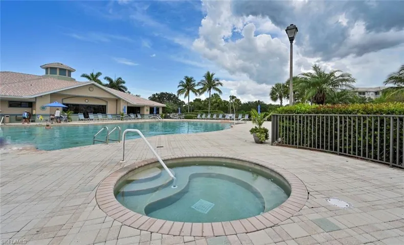 Community pool featuring a patio area and a community hot tub