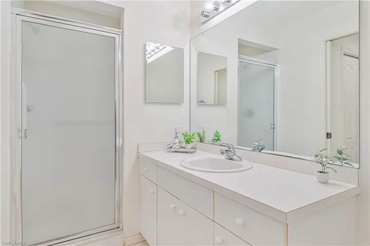 Bathroom with a shower stall and vanity