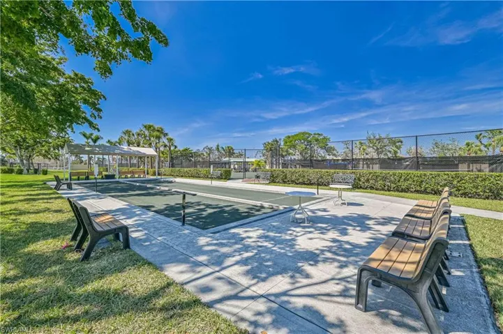 View of property's community with a game area and a patio area
