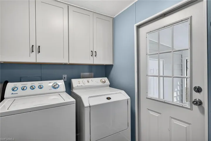 Laundry area featuring cabinet space and washing machine and clothes dryer