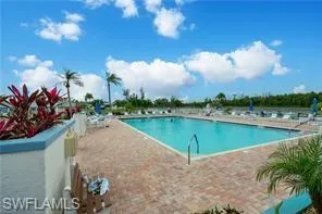 Community pool with a patio