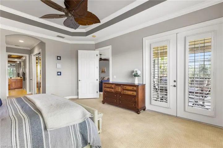 Wake up in your primary ensuite is a beautiful retreat with access to your lanai and golf and lake views!