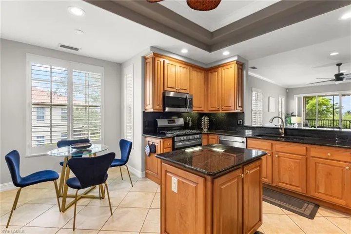Gas stove, granite countertops and an island.  Lots of natural light spills into the breakfast nook.