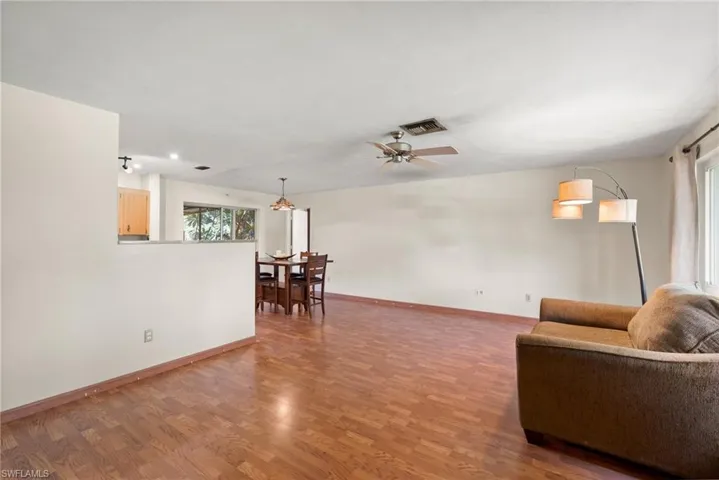 Living room featuring hardwood / wood-style flooring and ceiling fan