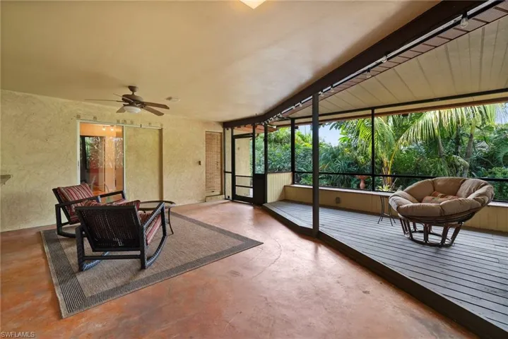 Sunroom / solarium featuring ceiling fan