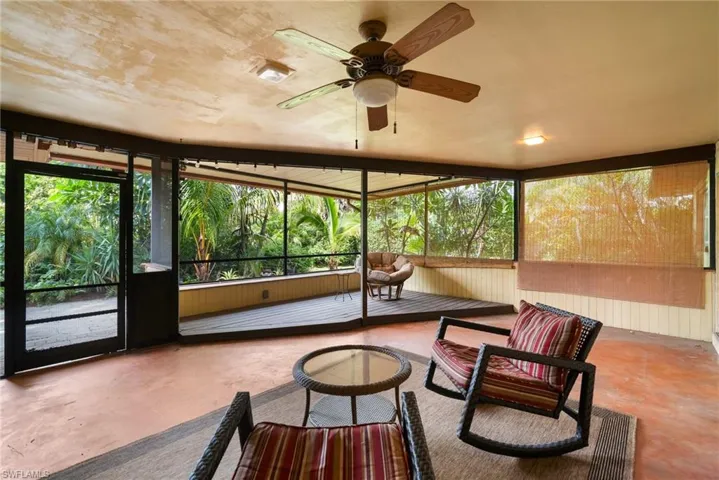 Sunroom / solarium featuring ceiling fan