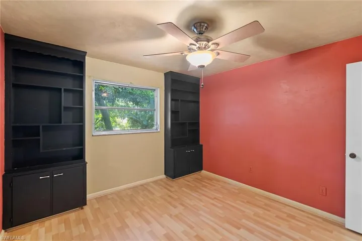 Unfurnished room with ceiling fan and light hardwood / wood-style floors
