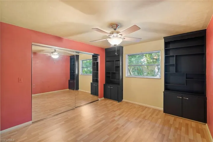 Unfurnished bedroom with ceiling fan, light wood-type flooring, and a closet