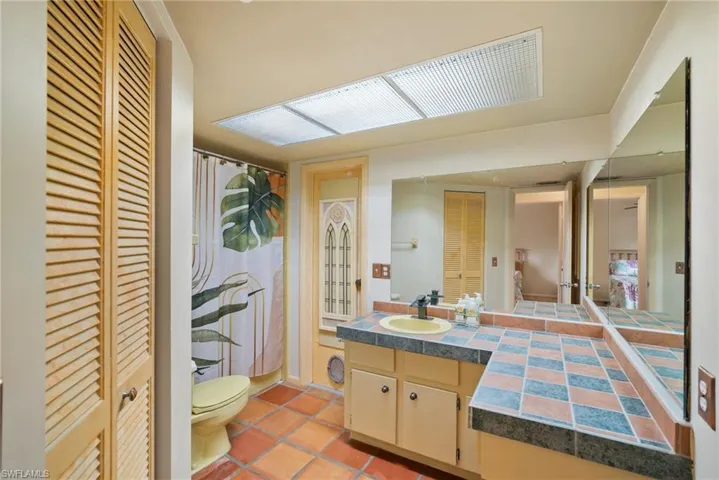 Bathroom with tile patterned floors, vanity, and toilet
