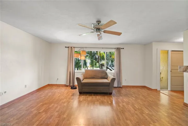 Sitting room with ceiling fan and light wood-type flooring