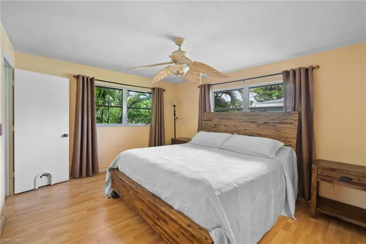 Bedroom with ceiling fan and light hardwood / wood-style flooring