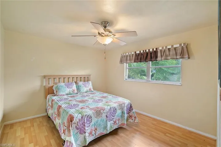 Bedroom with ceiling fan and light hardwood / wood-style flooring