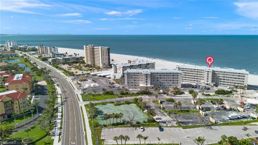 Aerial view of property's location with a large body of water and nearby urban area