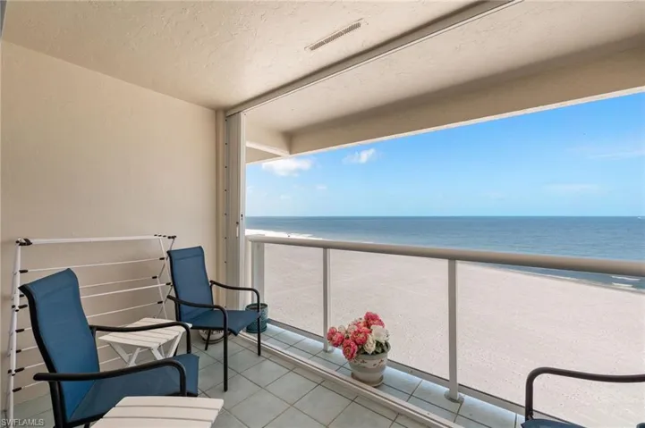Balcony with view of water and beach