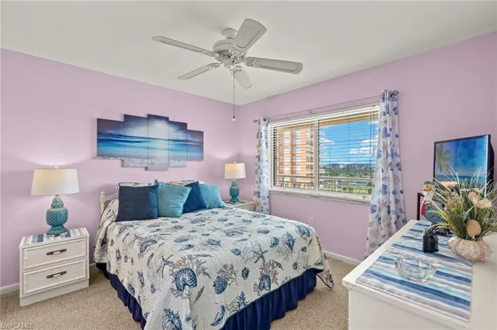 Bedroom featuring light colored carpet and a ceiling fan