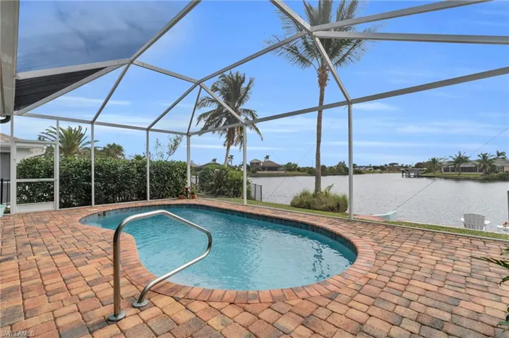 Pool with a lanai, a water view, and a patio area