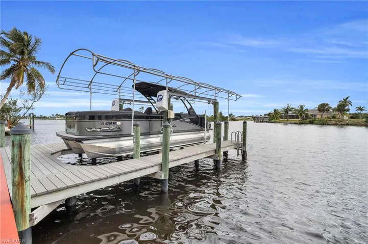 Dock area with a water view and boat lift
