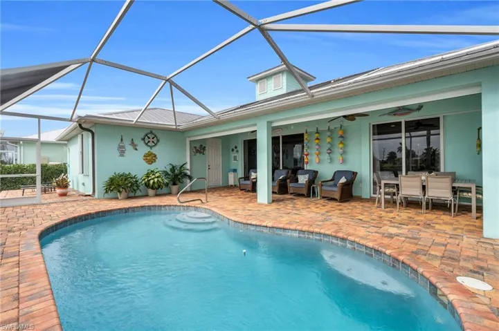 Outdoor pool featuring an outdoor living space, glass enclosure, ceiling fan, and a patio area