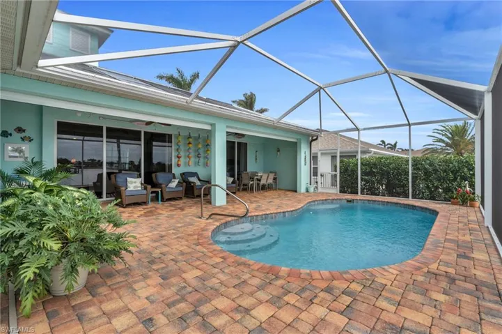 Pool with an outdoor living space, a lanai, a patio area, and a ceiling fan