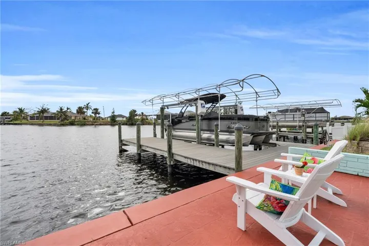 Dock area with a water view and boat lift