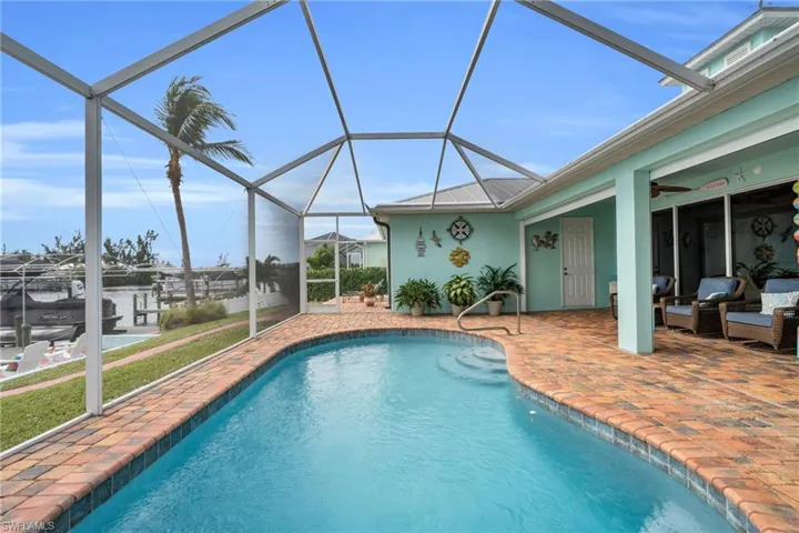 Outdoor pool featuring a ceiling fan, a lanai, and a patio