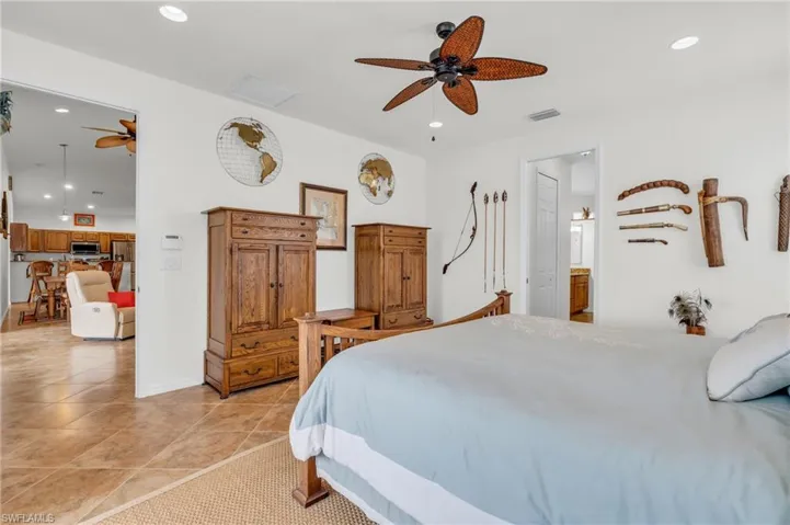 Bedroom featuring light tile patterned flooring, visible vents, ceiling fan, and recessed lighting