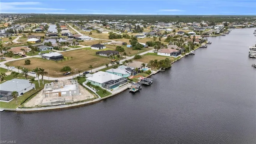 Birds eye view of property with a residential view and a water view