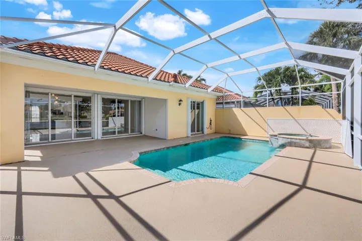 View of swimming pool with a sunroom, a patio, a pool with connected hot tub, and a lanai
