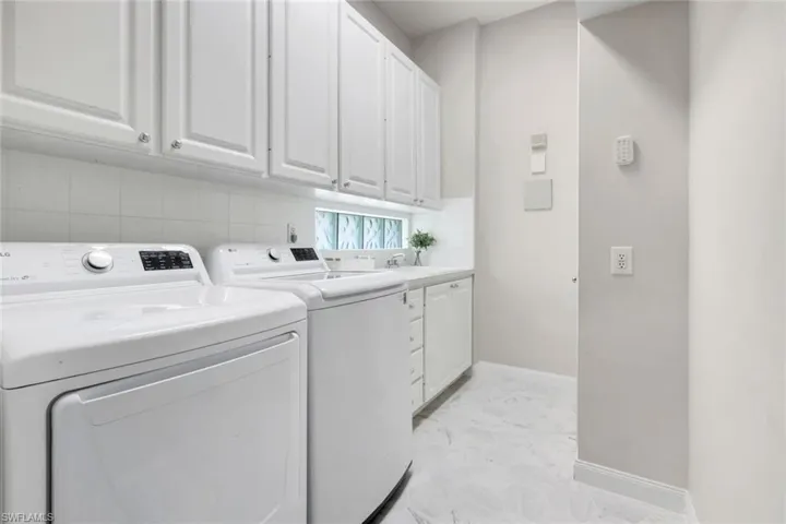 Laundry room with cabinet space and separate washer and dryer